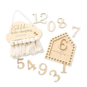 Wooden baby sleeping door sign and monthly milestone numbers set for nursery decor.