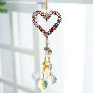 Crystal suncatcher detail showing colorful rhinestone heart and sparkling faceted crystal hanging prisms.
