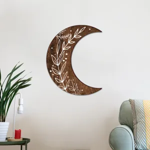 Bohemian wooden crescent moon wall art with white botanical print for living room decor.