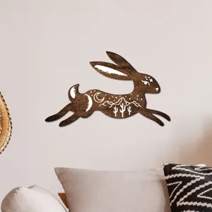 Detailed view of the bohemian wooden rabbit wall hanging in a cozy living room setup.