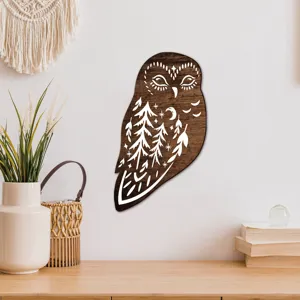 Detailed close-up of a bohemian wooden owl wall plaque featuring carved forest and moon patterns.