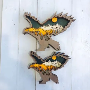 Detailed shot of multi-layered wooden eagle carving with mountain and forest landscape.