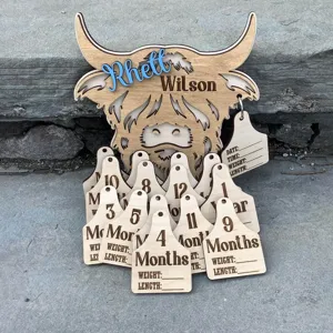 Custom wooden Highland cow baby milestone marker set with monthly tracker tags for newborn.