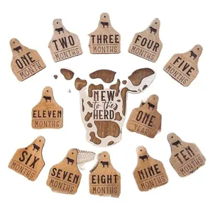 Wooden baby milestone markers with cow ear tag design, monthly photo props for newborns.