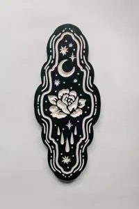 Gothic mystical wooden wall hanging detail showcasing intricate carved moon stars and rose motifs.