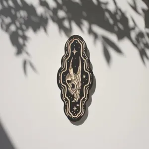 Detailed view of gothic style wooden wall plaque featuring intricate skull carving and stars.