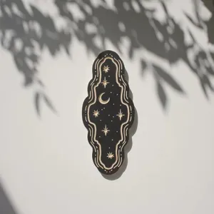 Detailed shot of celestial carved wooden wall hanging plaque with stars and moon aesthetic decor.