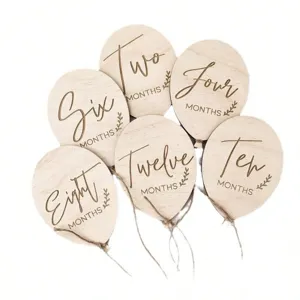 Wooden baby monthly milestone balloon props detail view, newborn photography keepsake items.