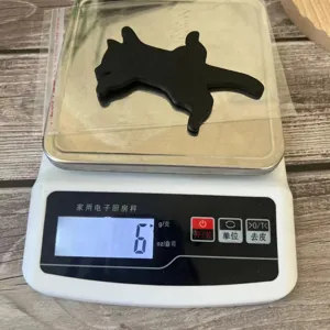 Wooden black cat silhouette wall decor detail shot showing weight on scale, lightweight design.