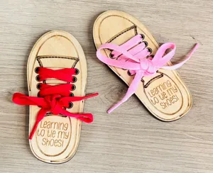 Close-up detail of wooden shoe lacing practice board for kids learning educational toy.