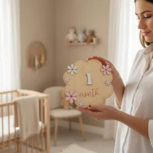 Close-up of wooden baby milestone month plaque with white daisy flowers for newborn photography.