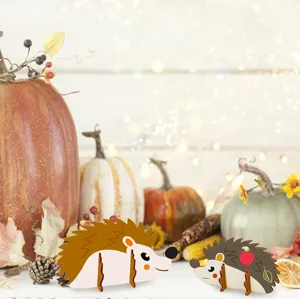 Detailed autumn scene showcasing wooden hedgehog crafts with pumpkins and autumn leaves decor.