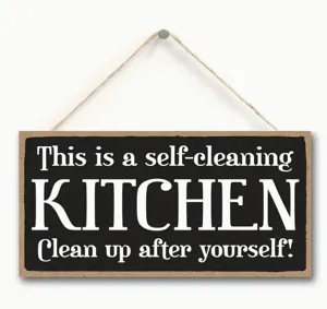 Wooden kitchen hanging sign detail showing rustic black board and clear white text typography.