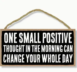Detailed close-up of the wooden hanging sign featuring inspirational quote typography. Perfect decor.