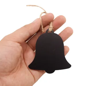 Close-up detail of the wooden bell-shaped message chalkboard pendant with rustic hanging twine.