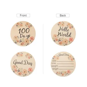 Wooden floral baby milestone cards detail view, round wooden cards with newborn record text.