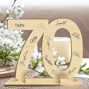 Wooden number 70 display stand detail showing custom engraved names and anniversary years for party.