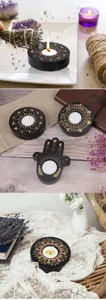 Detailed shot of wooden tealight candle holders featuring zodiac and mandala designs.