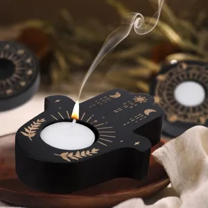 Wooden Hamsa hand tealight candle holder with celestial sun and moon carvings.