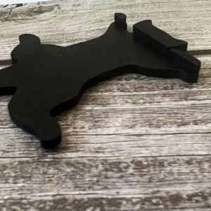 Detail shot of the black wooden cat door corner decoration showcasing its sleek silhouette.