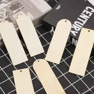 Wooden blank bookmarks detail showing rectangular shapes with hanging holes on grid fabric.
