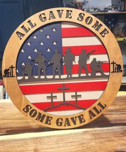 Wooden patriotic wall sign with American flag and soldier silhouettes for US independence day.
