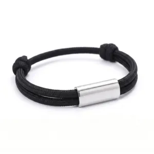Handmade black paracord bracelet with stainless steel tube, adjustable minimalist rope jewelry.