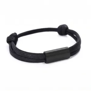 Black stainless steel tube braided rope bracelet detail shot, minimalist design fashion jewelry.