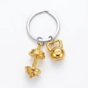 Gym fitness dumbbell and kettlebell metal keychain pendant detail view for sports lovers.