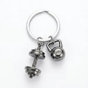 Detailed view of the metal dumbbell and kettlebell sports keychain, gym fitness accessory.