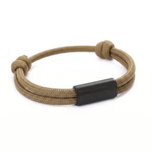 Close-up view of hand-woven paracord bracelet detail with sleek black metal tube clasp.