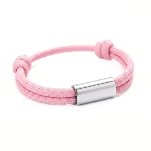 Close-up detail of the pink braided paracord bracelet featuring a polished stainless steel tube.