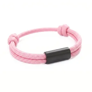 Pink paracord bracelet detail, handmade woven rope with black stainless steel tube.