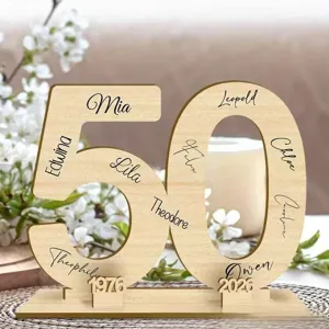 Detailed shot of a personalized wooden number 50 display stand with engraved names and dates.