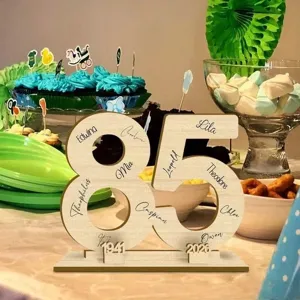 Wooden number 85 sign detail shot showing personalized custom names and commemorative dates clearly.