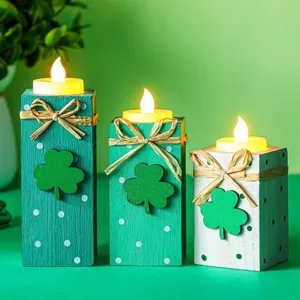 Detailed view of wooden St. Patrick's Day tea light candle holders with clover decor and LEDs.