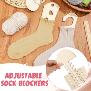 Detail shot of adjustable wooden sock blockers showing size adjustment mechanism and knitted socks.