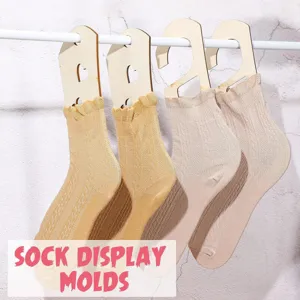 Detailed view of wooden sock display molds hanging on rod, ideal for knitting and sock presentation.