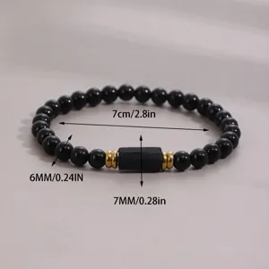 Detail view of black beaded stone bracelet featuring gold spacers and clear measurements.