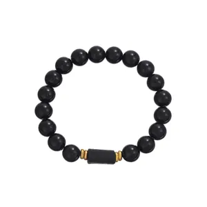 Detailed view of black beaded bracelet showcasing central rectangular accent with gold spacers.