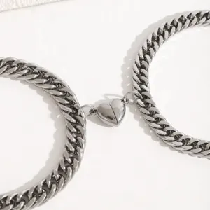 Stainless steel magnetic couple cuban chain detail view, close up silver metal links showcase.
