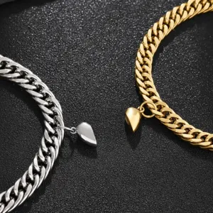Stainless steel magnetic couple cuban link bracelet detail, matching heart charms for lovers.