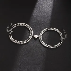 Stainless steel magnetic heart Cuban chain bracelet pair close up view detailed shot.