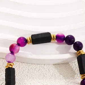 Purple agate and black stone beaded bracelet detail shot, elegant jewelry accessory.