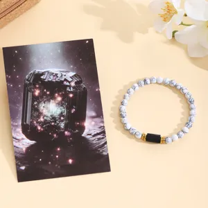 White turquoise bead bracelet with black centerpiece and gold spacers for women fashion jewelry.