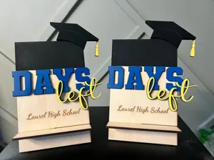 Wooden graduation countdown desk decor sign with cap and days left text for school.