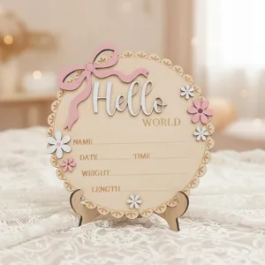 Wooden newborn birth announcement plaque close-up, baby milestone photography prop detail.