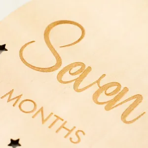 Wooden baby 7 months milestone card detail, natural wood engraved photography prop.