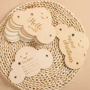 Wooden baby cloud milestone cards detail showing engraved English text and record fields.