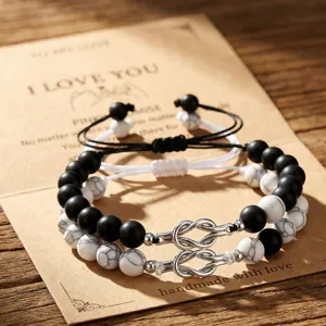 Detailed closeup of couple natural stone and matte black bead bracelets with silver love knot.